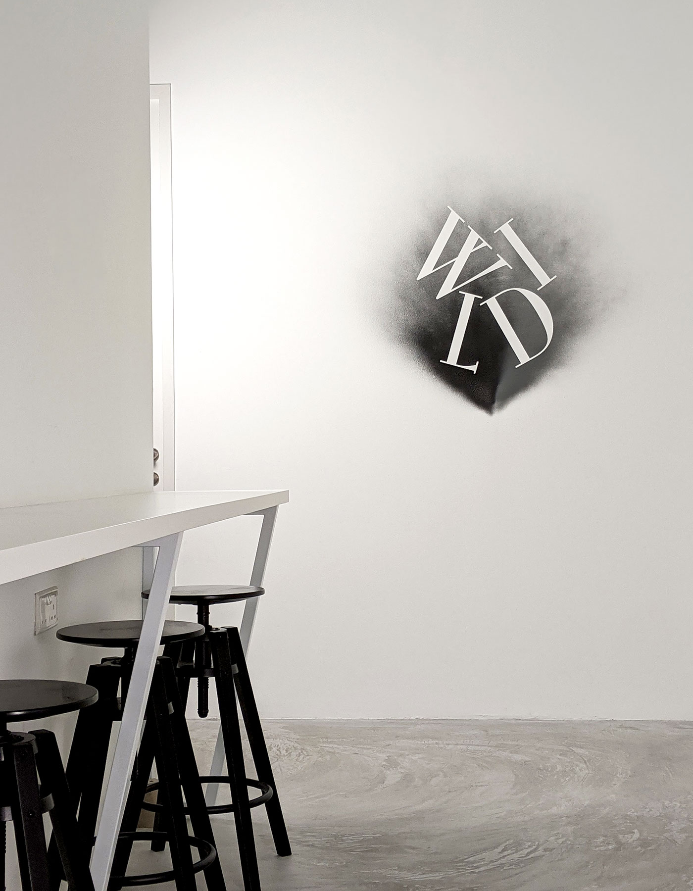 Interior of Wild Advertising & Marketing’s office, a Singapore-based creative agency, with its logo on the wall