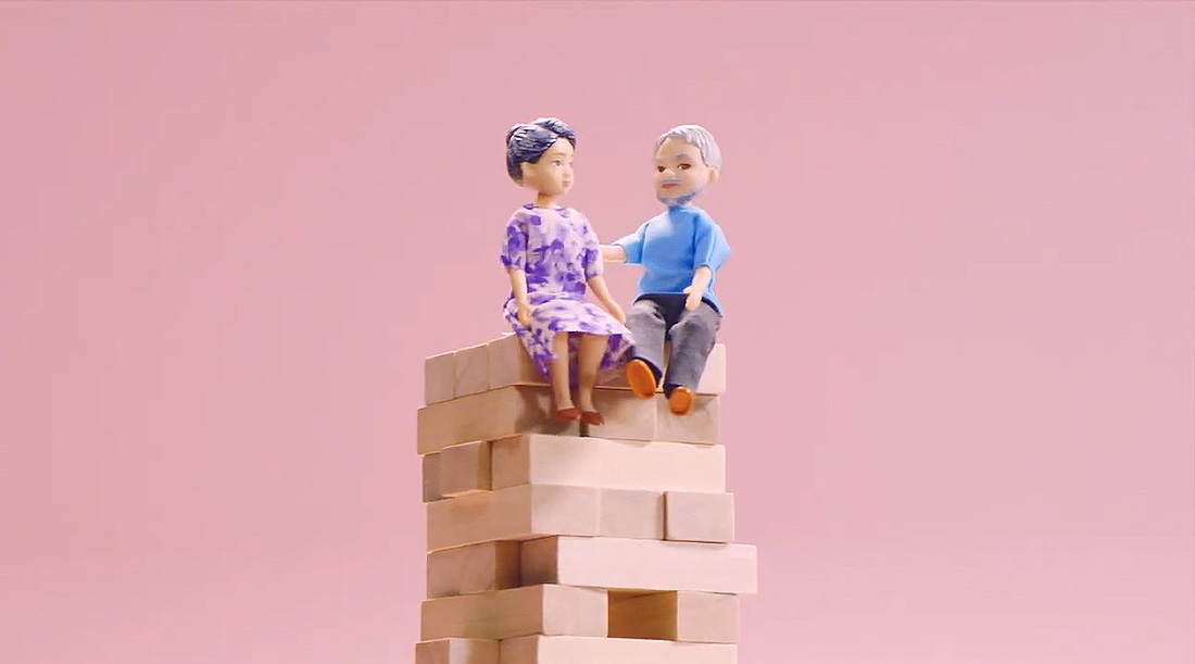 A composite of an elderly doll couple on a jenga tower for CPF Board’s social media campaign on retirement planning